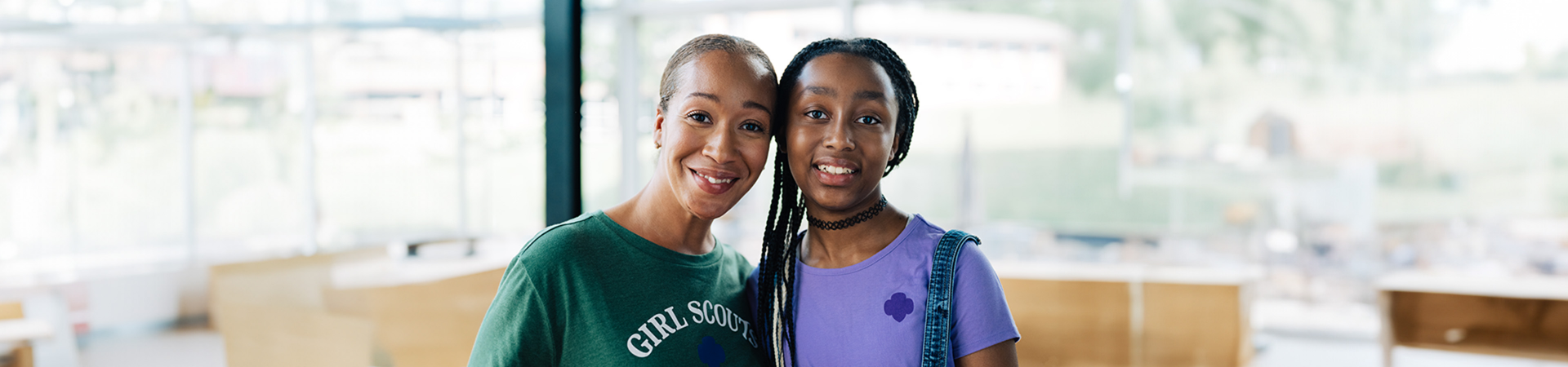  adult woman girl scout volunteer outdoors with junior girl scout 