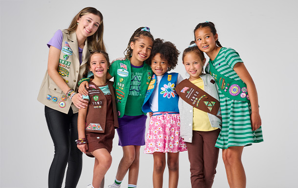 Six Girl Scouts of various ages with their arms around each other