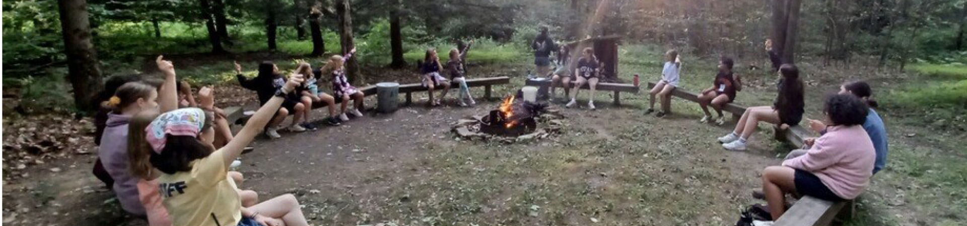  Girls sitting around a campfire 