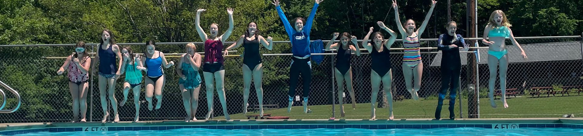  Girl Scouts jumping into a pool 