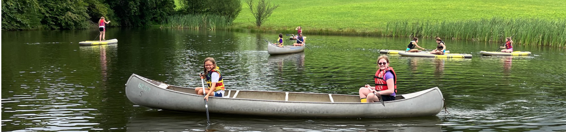  two girls paddling in a canoe 