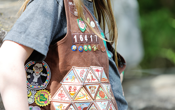 girl scout vest with lots of badges