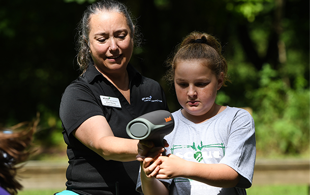 girl scout and adult using a speedometer