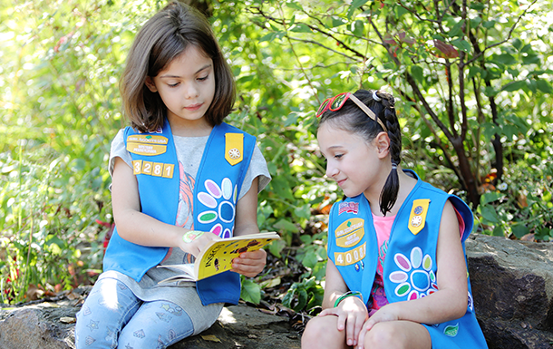 Girl Scout Daisies reading a book on insects together