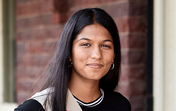 Single girl smiling at the camera, wearing a sash