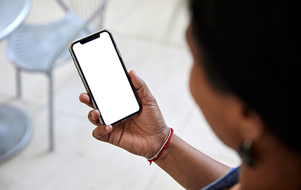 adult volunteer looking at a cell phone